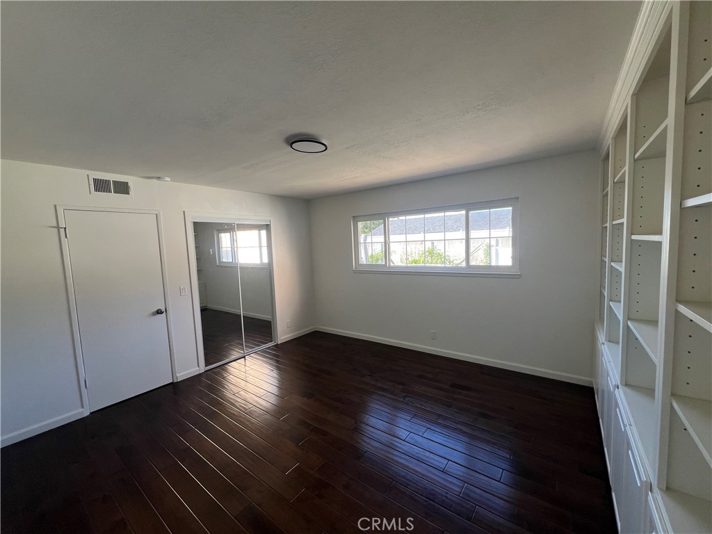 16091 Gold Huntington Beach Huntington Beach, CA 92647 - Photo 6 of 9 a view of an empty room with wooden floor and a window