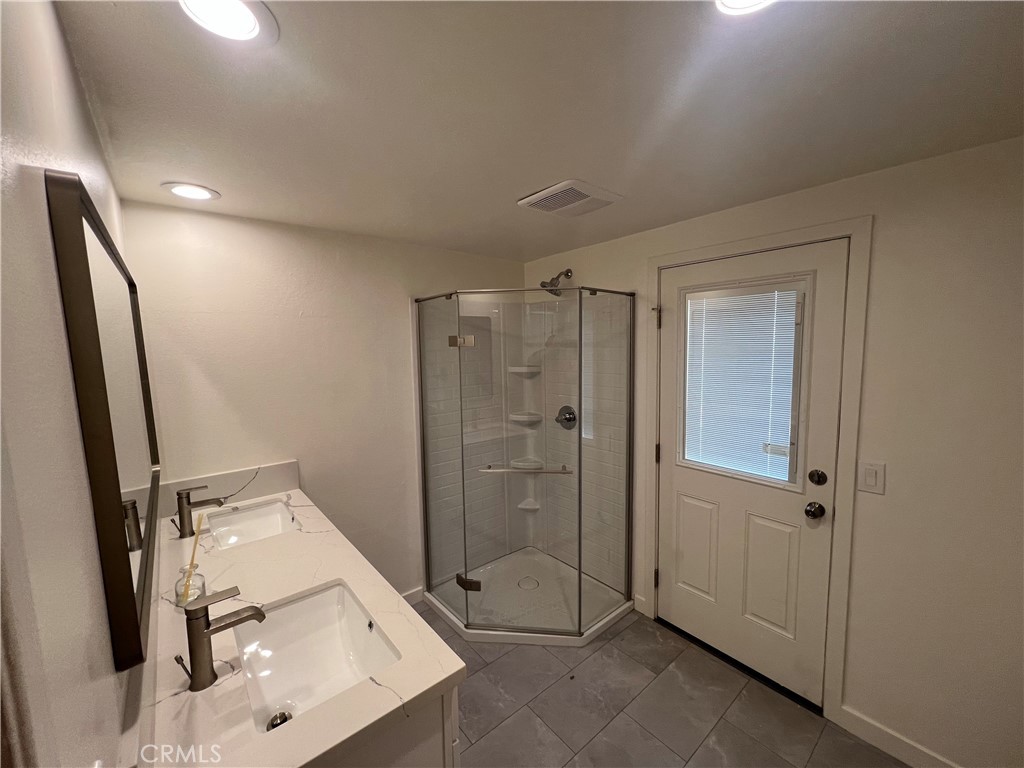 16091 Gold Huntington Beach Huntington Beach, CA 92647 - Photo 7 of 9 a bathroom with a shower sink and mirror