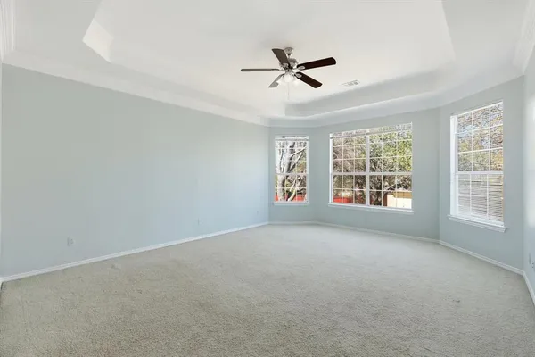 an empty room with a empty shelves and natural light