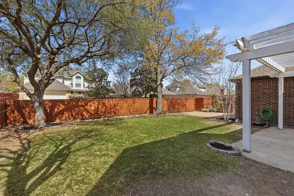 a front view of a house with a garden and yard