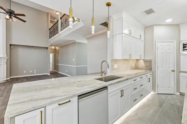 an empty room with windows and fireplace