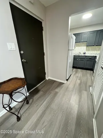 a kitchen with a sink a stove top oven a refrigerator and cabinets