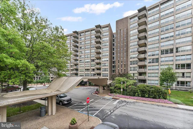 a view of a patio with a table and chairs and potted plants