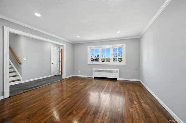 a view of room with wooden floor and window