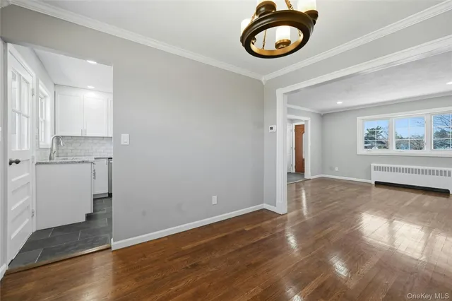 a view of a room with wooden floor and window