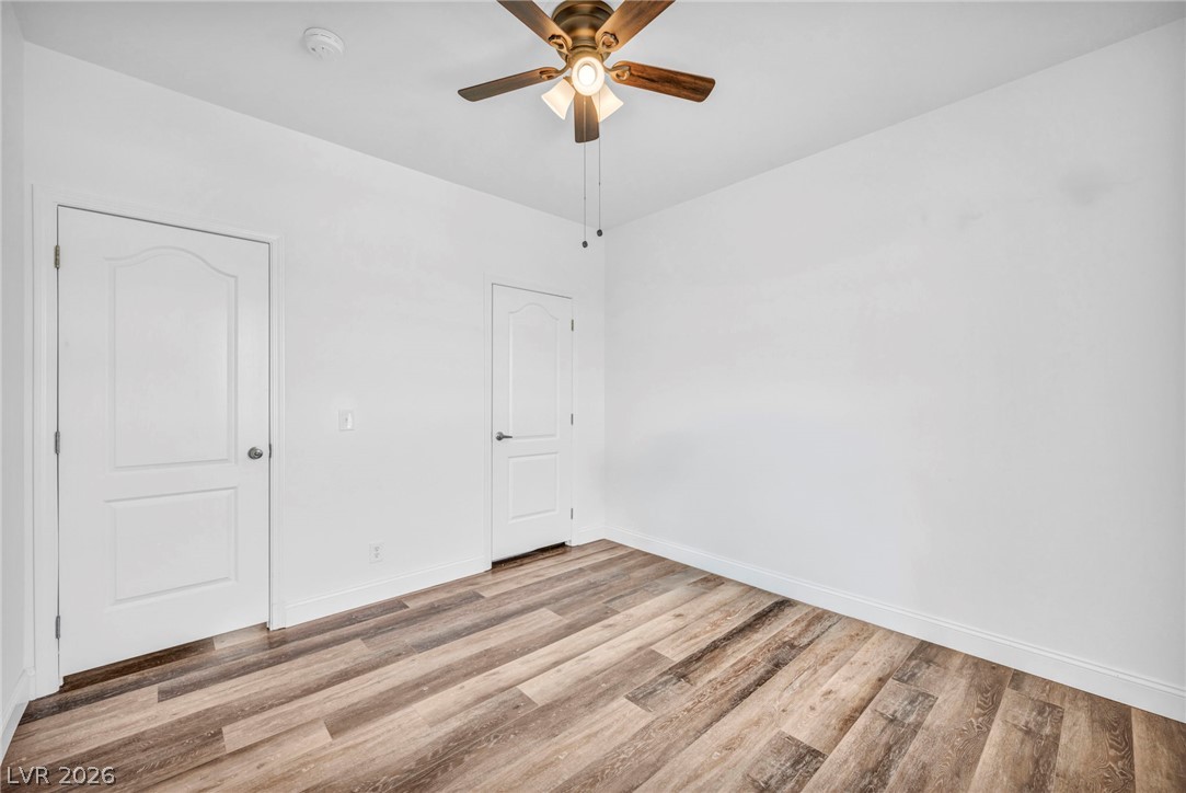 225 California Street Searchlight, NV 89046 - Photo 36 of 64 Warm wood-look flooring and a ceiling fan create a comfortable atmosphere for rest or rejuvenation.