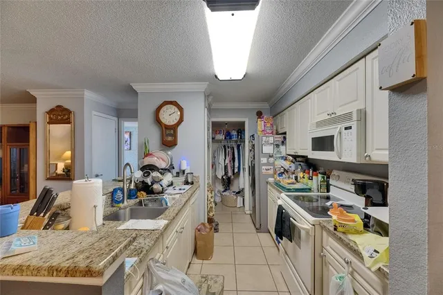a kitchen with a stove a faucet and cabinets
