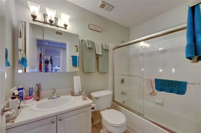 a bedroom with a bed and ceiling fan