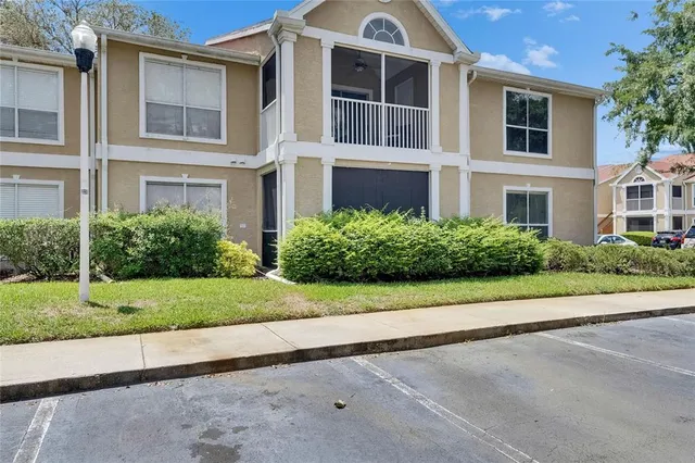 a front view of multiple houses with yard