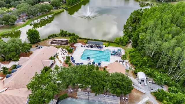 an aerial view of a house with a garden and lake view