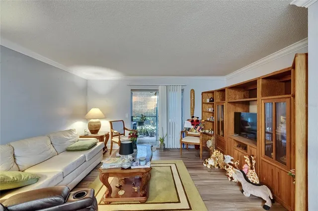 a living room with furniture a flat screen tv and a large window