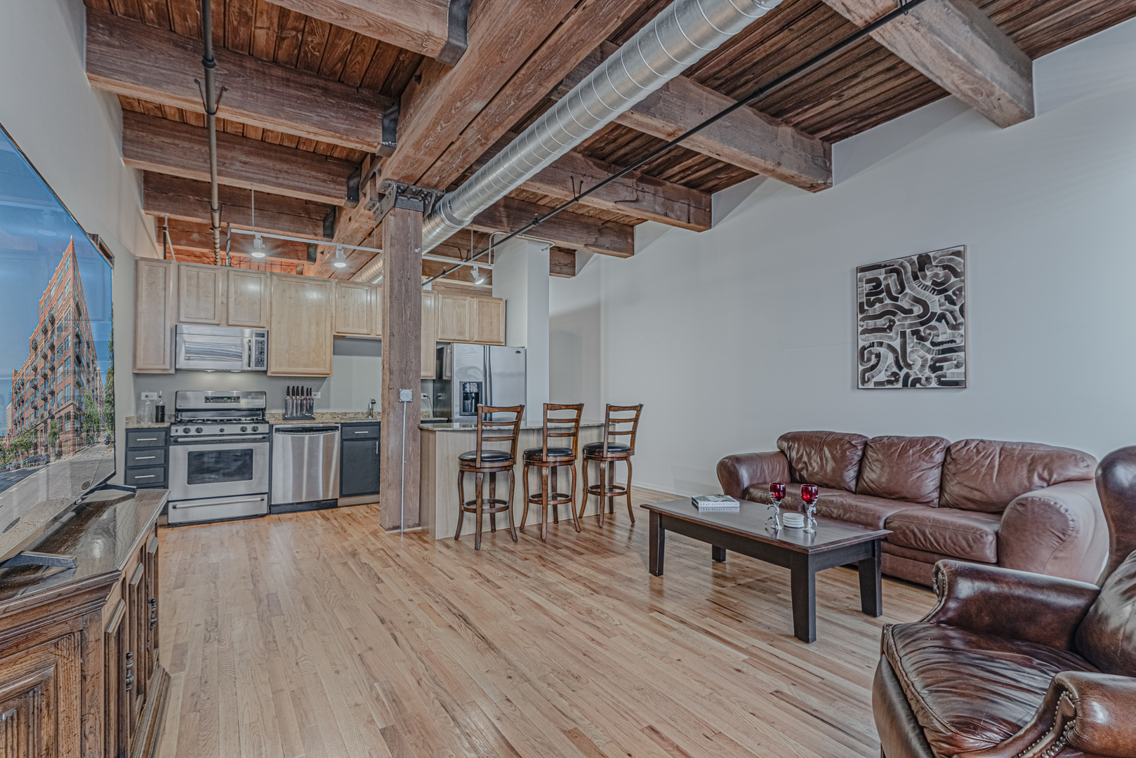 1500 West Monroe Street, Unit 517 Chicago, IL 60607 - Photo 2 of 26 a living room with lots of wooden furniture and a wooden floor