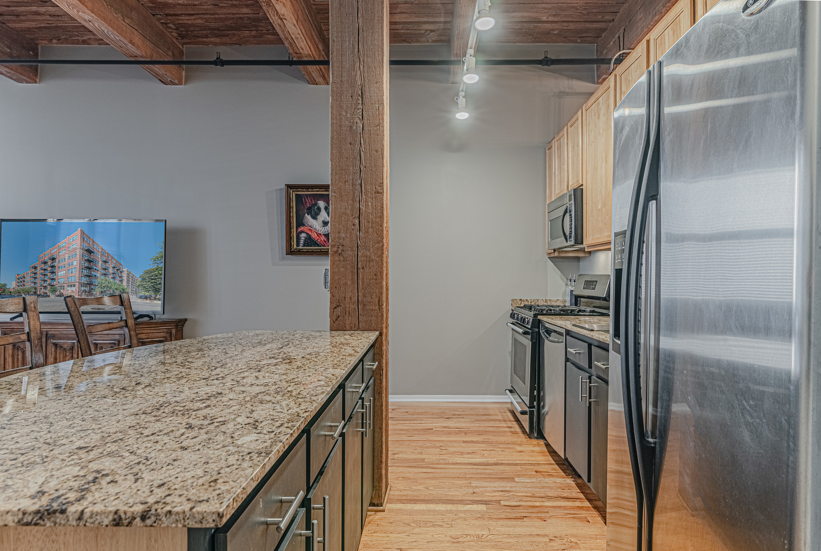 1500 West Monroe Street, Unit 517 Chicago, IL 60607 - Photo 10 of 26 a kitchen with kitchen island a counter top space and refrigerator