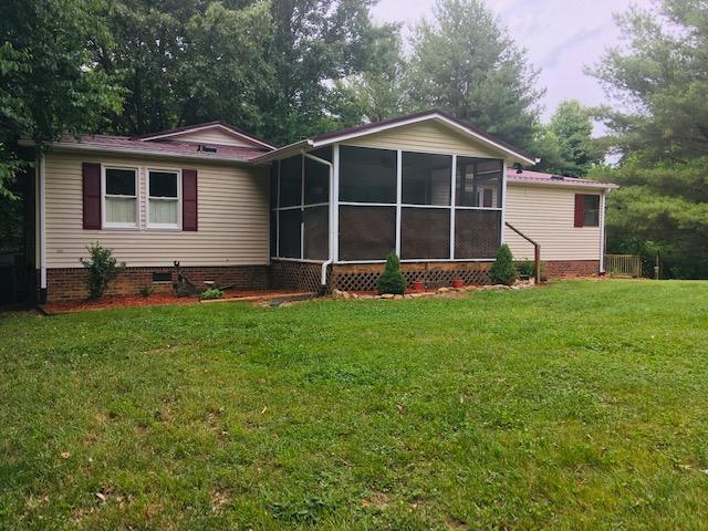 1315 Depot Road Blue Ridge, VA 24064 - Photo 1 of 17 a front view of a house with a yard and trees