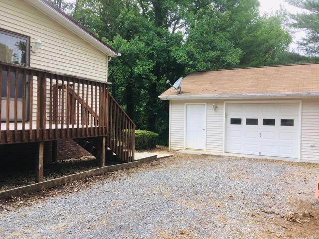 1315 Depot Road Blue Ridge, VA 24064 - Photo 2 of 17 a front view of a house with a yard and garage