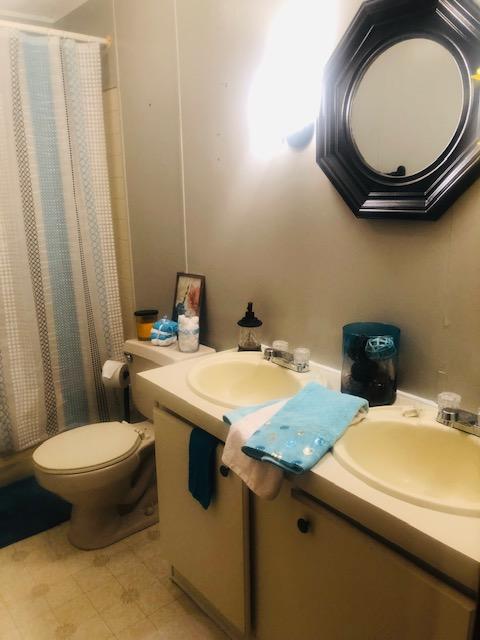 1315 Depot Road Blue Ridge, VA 24064 - Photo 12 of 17 a bathroom with a toilet a sink and a mirror