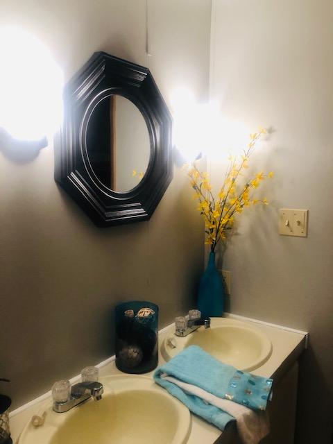 1315 Depot Road Blue Ridge, VA 24064 - Photo 14 of 17 a bathroom with a granite countertop toilet and a sink