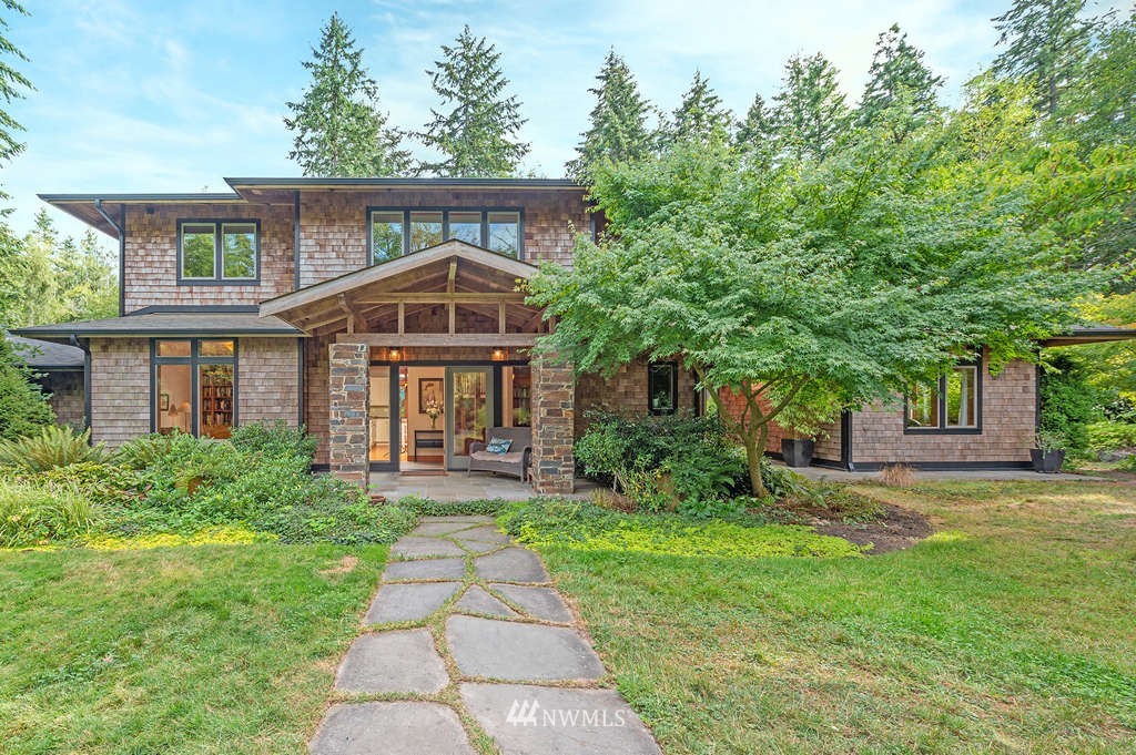 18132 Thorsen Road Southwest Vashon, WA 98070 - Photo 1 of 40 a front view of a house with garden