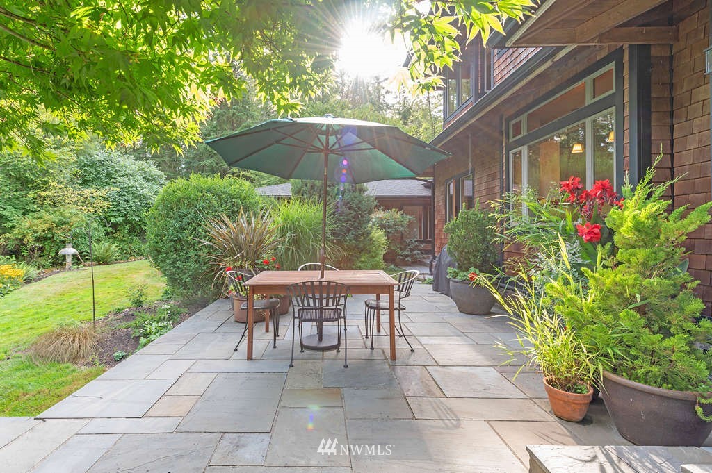 18132 Thorsen Road Southwest Vashon, WA 98070 - Photo 14 of 40 a view of a patio with table and chairs under an umbrella