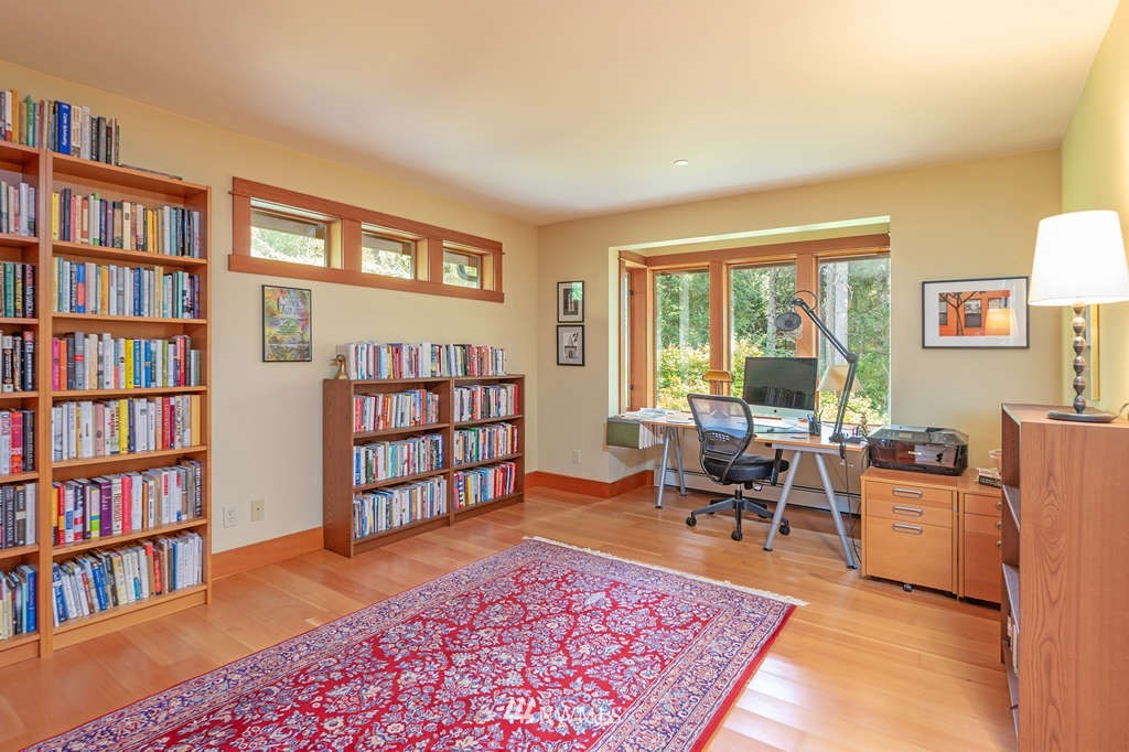18132 Thorsen Road Southwest Vashon, WA 98070 - Photo 17 of 40 a living room with furniture and a book shelf