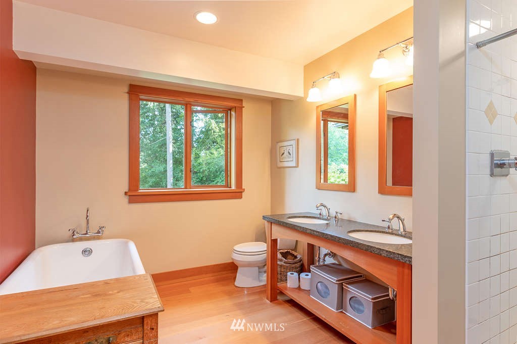 18132 Thorsen Road Southwest Vashon, WA 98070 - Photo 18 of 40 a bathroom with a sink tub double vanity and window