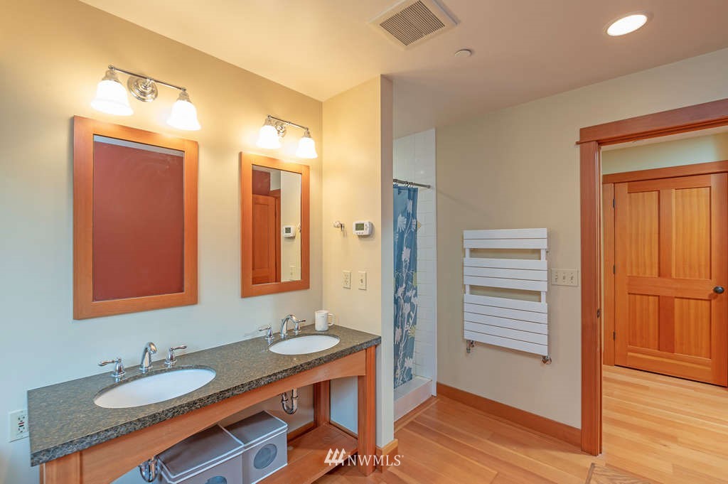 18132 Thorsen Road Southwest Vashon, WA 98070 - Photo 19 of 40 a bathroom with a granite countertop sink and a mirror