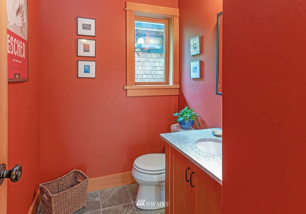 18132 Thorsen Road Southwest Vashon, WA 98070 - Photo 22 of 40 a bathroom with a granite countertop toilet and a sink