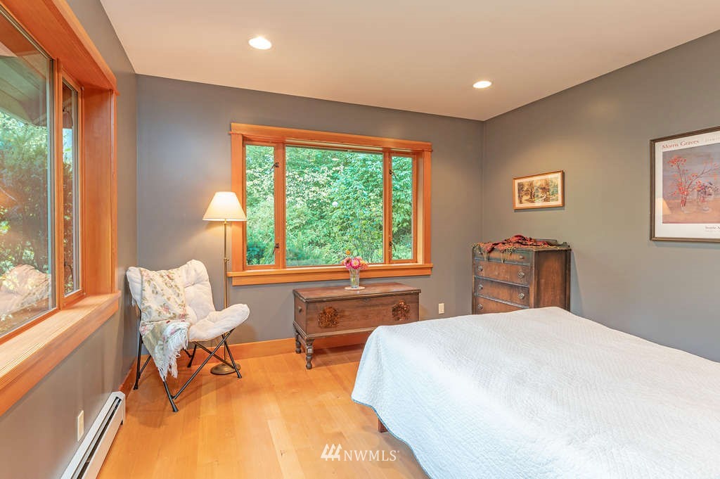 18132 Thorsen Road Southwest Vashon, WA 98070 - Photo 25 of 40 a bedroom with a bed and a large window