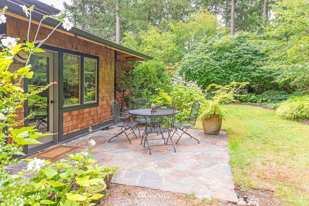 18132 Thorsen Road Southwest Vashon, WA 98070 - Photo 30 of 40 a view of a patio with table and chairs and potted plants