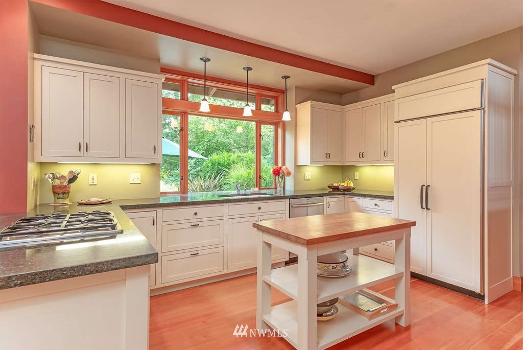 18132 Thorsen Road Southwest Vashon, WA 98070 - Photo 4 of 40 a kitchen with stainless steel appliances granite countertop a sink stove and refrigerator