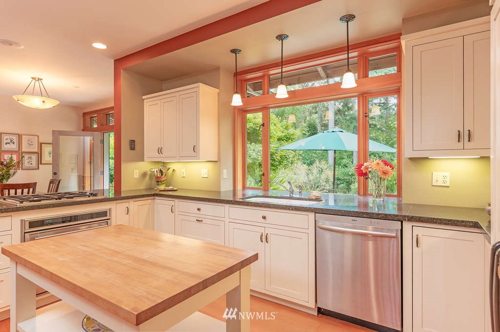 18132 Thorsen Road Southwest Vashon, WA 98070 - Photo 5 of 40 a kitchen with a large window appliances and cabinets