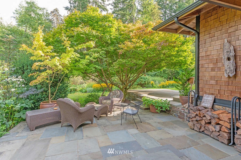18132 Thorsen Road Southwest Vashon, WA 98070 - Photo 9 of 40 a view of a patio with table and chairs and potted plants