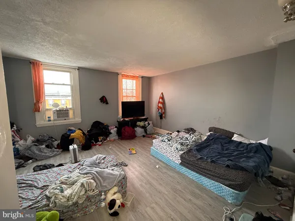a bedroom with a bed and a flat tv screen