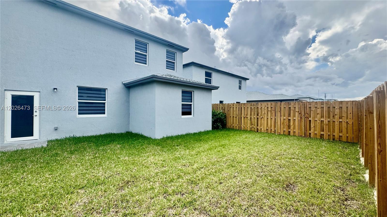 19479 Southwest 340th Street, Unit 1 Homestead, FL 33034 - Photo 50 of 58 a backyard of a house with lots of green space