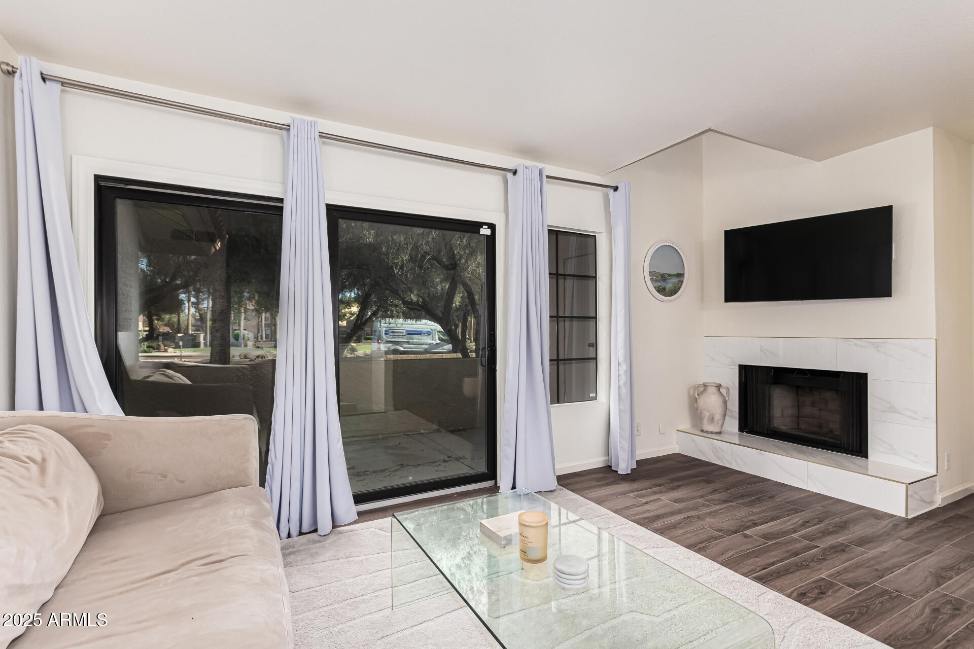 8700 East Mountain View Road, Unit 1039 Scottsdale, AZ 85258 - Photo 11 of 37 a living room with a fireplace and a flat screen tv