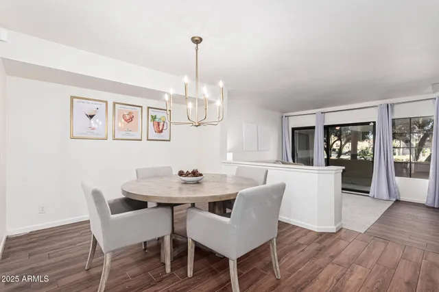a living room with furniture and a dining table with wooden floor