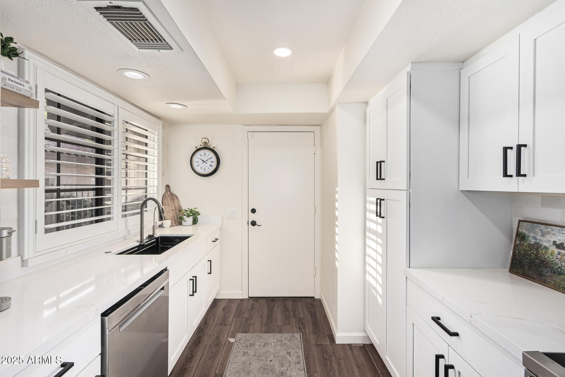 8700 East Mountain View Road, Unit 1039 Scottsdale, AZ 85258 - Photo 15 of 37 a kitchen with granite countertop a sink stove and cabinets
