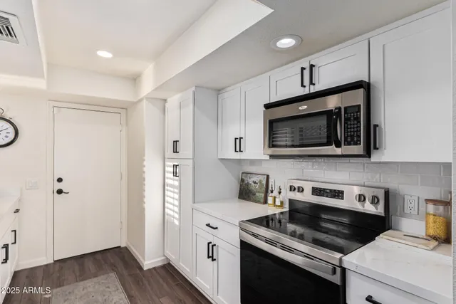 a view of a dining room with furniture wooden floor and chandelier