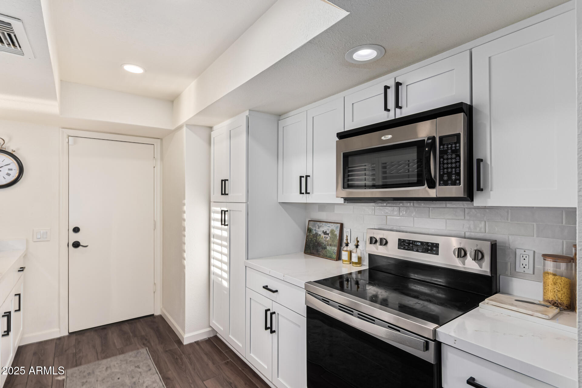 8700 East Mountain View Road, Unit 1039 Scottsdale, AZ 85258 - Photo 16 of 37 a kitchen with stainless steel appliances a stove microwave and sink