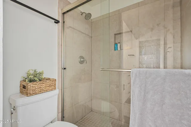 a bedroom with a bed and a mirror