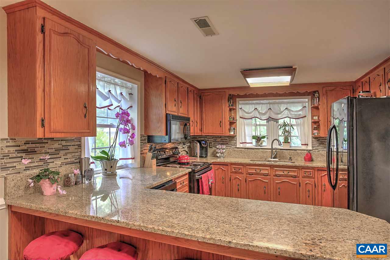 64 Horseshoe Hill Road Ruckersville, VA 22968 - Photo 5 of 33 a kitchen with stainless steel appliances granite countertop a sink refrigerator stove and microwave