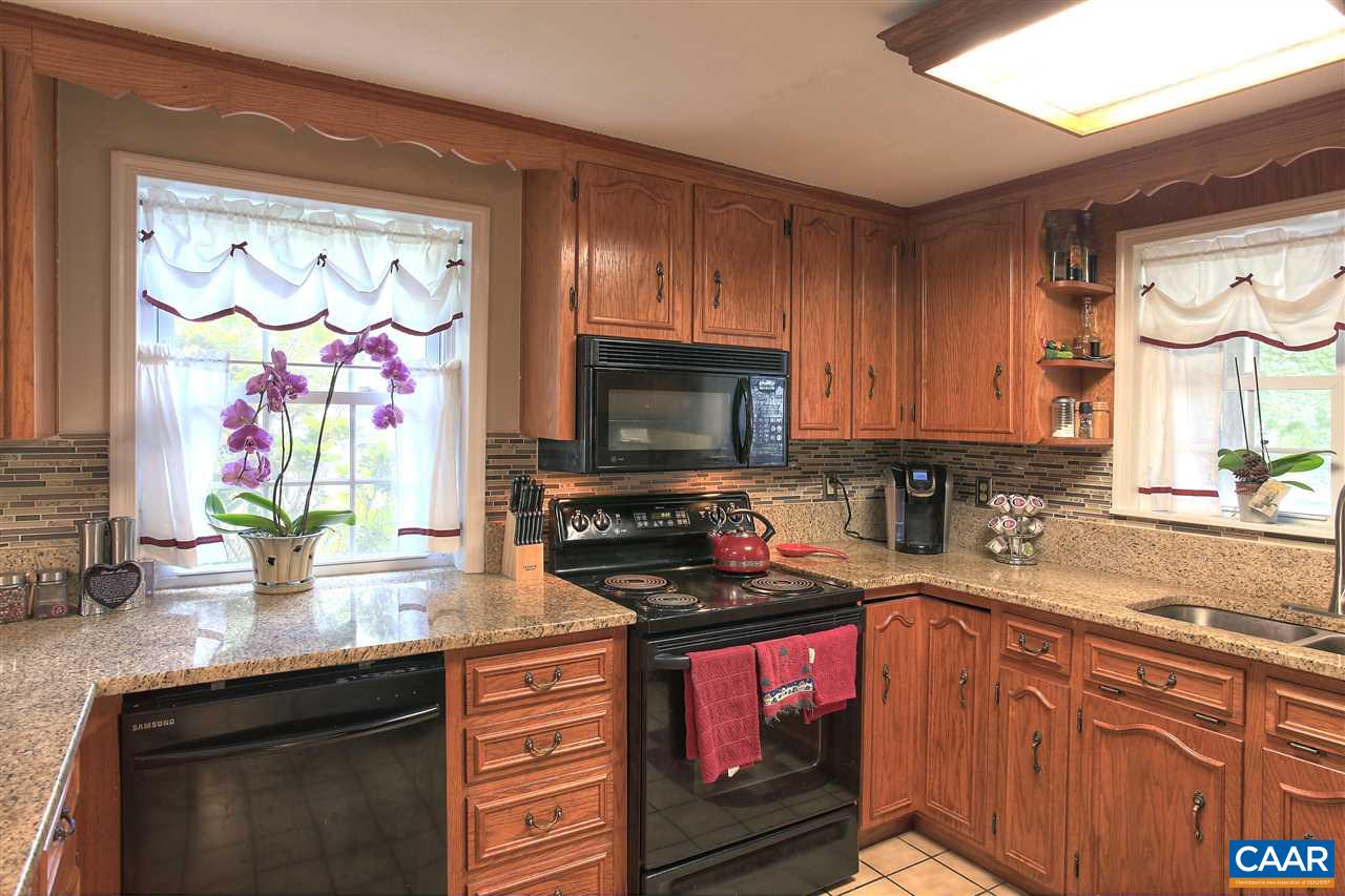 64 Horseshoe Hill Road Ruckersville, VA 22968 - Photo 6 of 33 a kitchen with stainless steel appliances granite countertop a stove a sink and a microwave