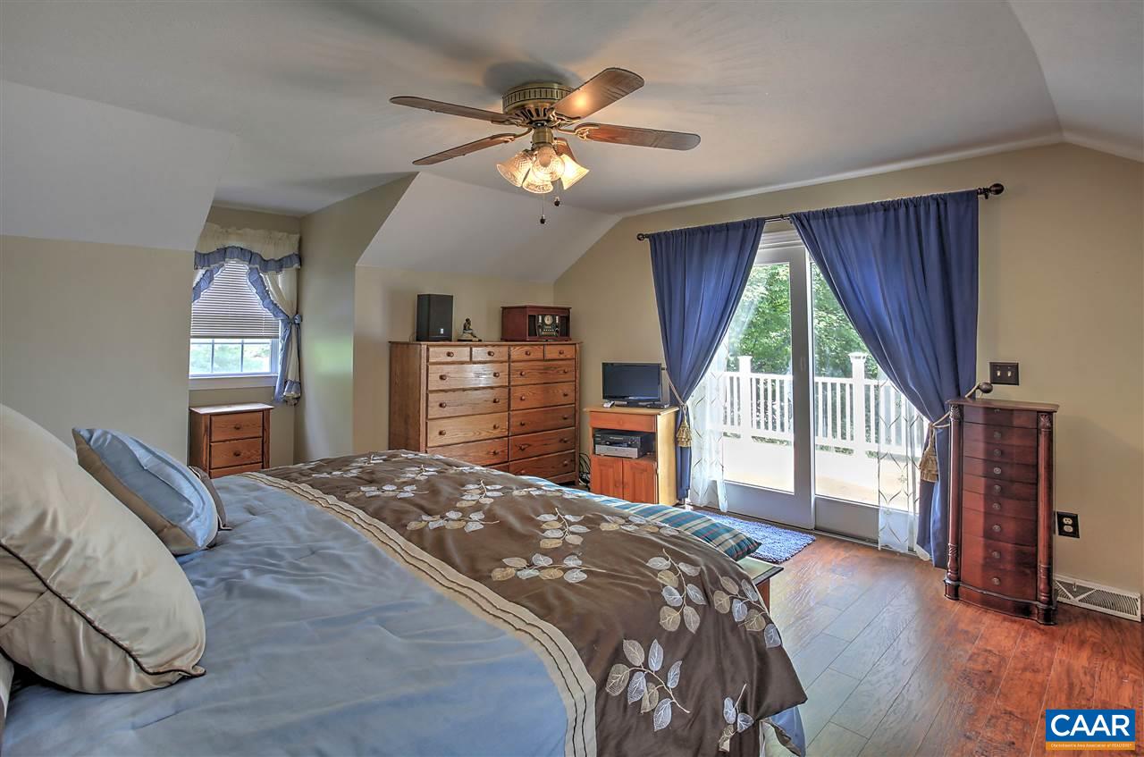 64 Horseshoe Hill Road Ruckersville, VA 22968 - Photo 10 of 33 a bedroom with a large bed and a large window