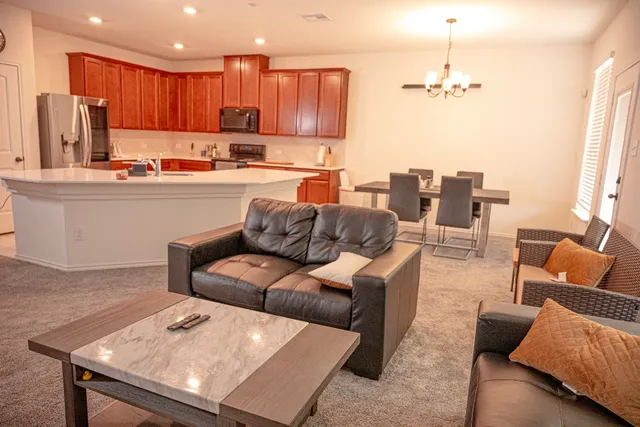 a kitchen with stainless steel appliances a refrigerator and a stove top oven