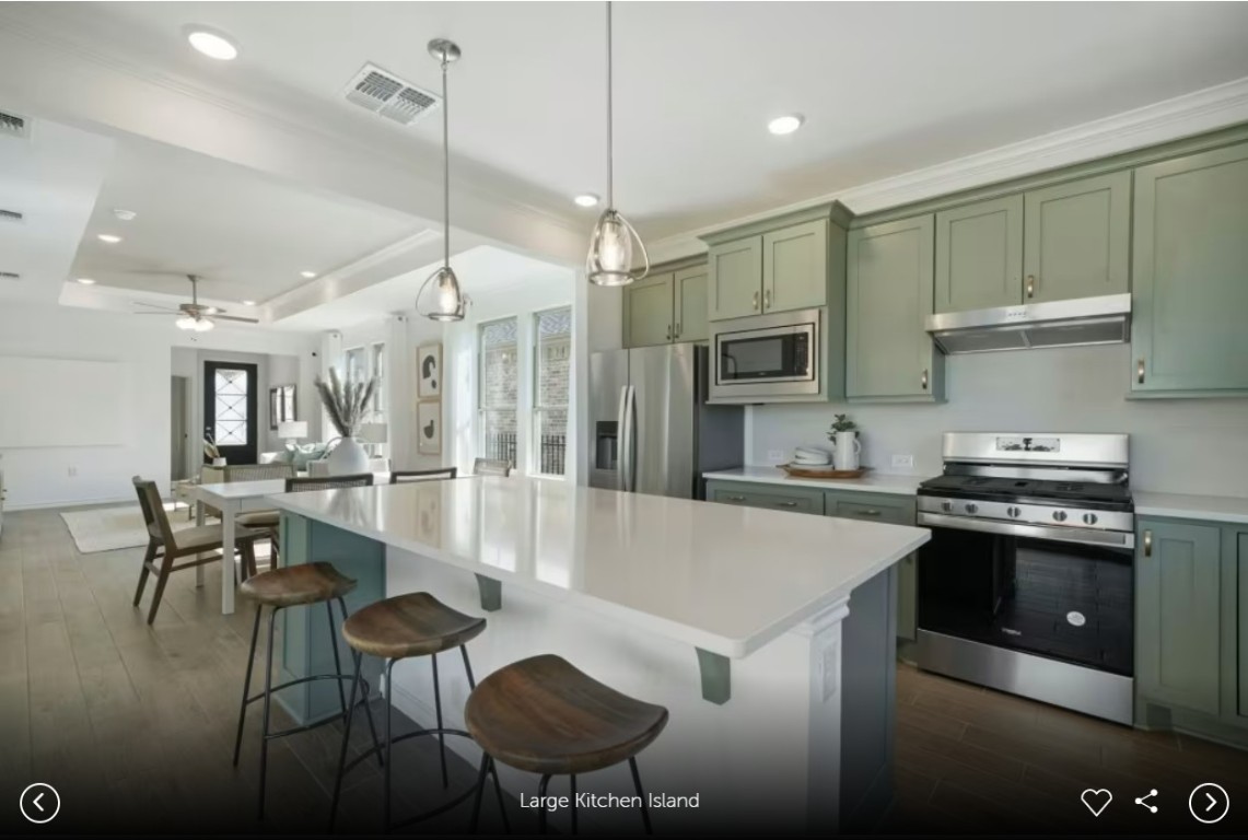 126 Kimberwick Court Georgetown, TX 78633 - Photo 5 of 10 a kitchen with stainless steel appliances granite countertop a stove a refrigerator a kitchen island a dining table and chairs with wooden floor