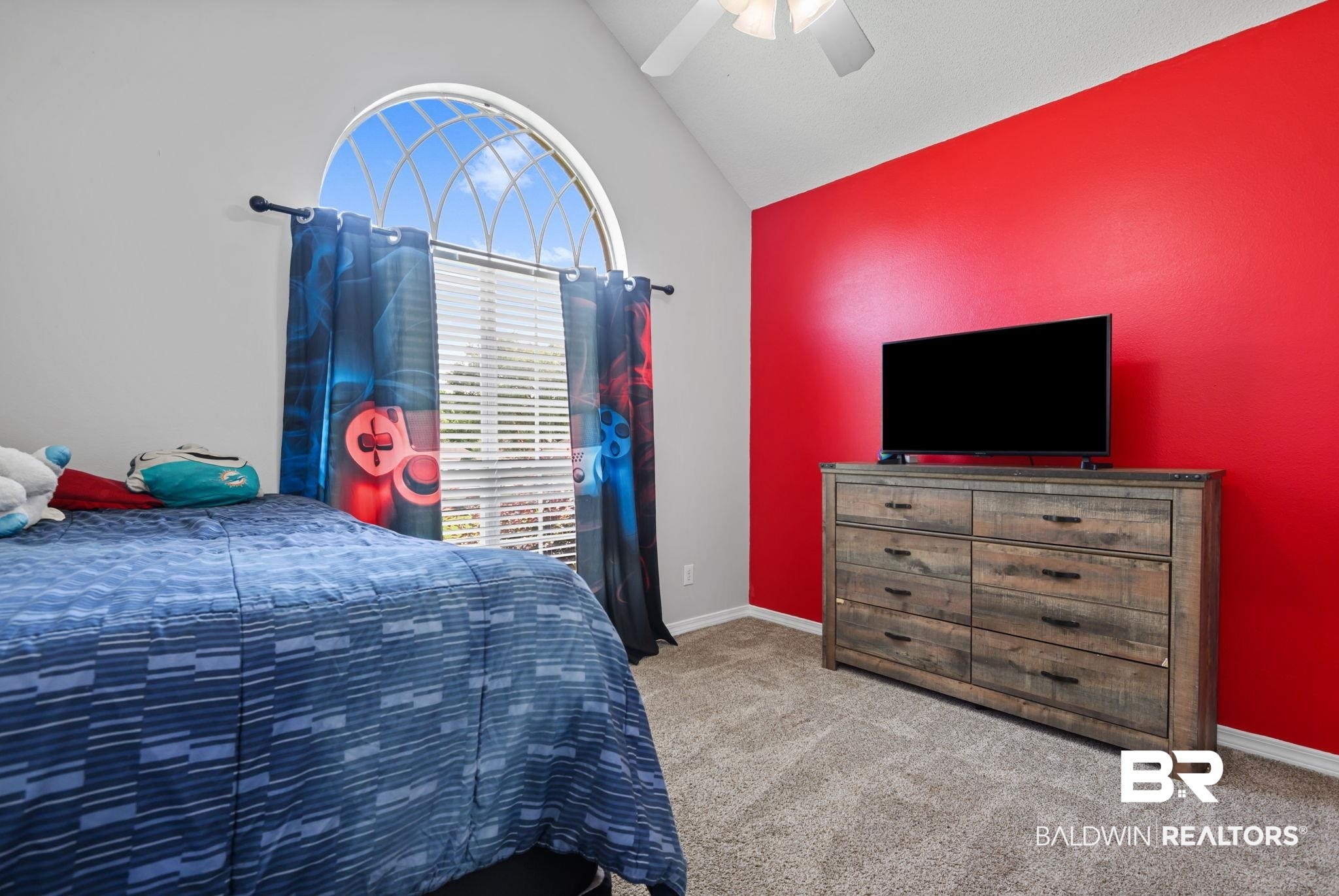 9422 Labrador Run South Mobile, AL 36695 - Photo 29 of 36 Arched window with decorative grilles, vaulted ceiling, and ceiling fan