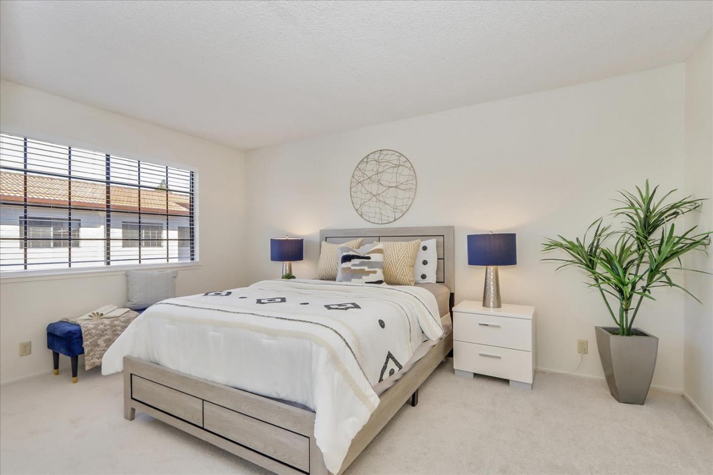430 Costa Mesa Terrace, Unit E Sunnyvale, CA 94085 - Photo 12 of 40 a bedroom with bed and a potted plant
