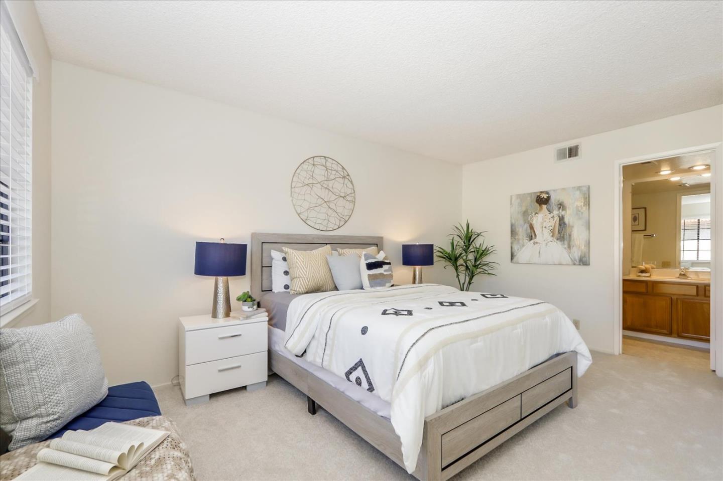 430 Costa Mesa Terrace, Unit E Sunnyvale, CA 94085 - Photo 13 of 40 a bedroom with bed and a large mirror on the dresser