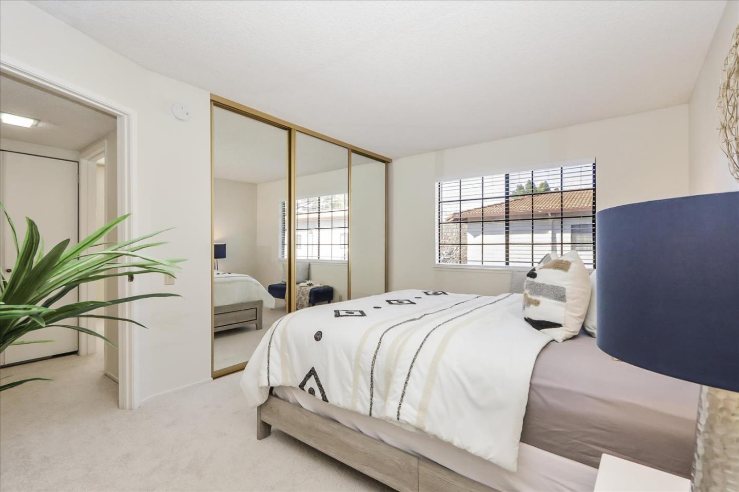 430 Costa Mesa Terrace, Unit E Sunnyvale, CA 94085 - Photo 14 of 40 a bedroom with a bed and a potted plant