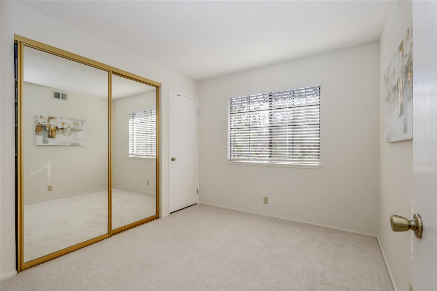 430 Costa Mesa Terrace, Unit E Sunnyvale, CA 94085 - Photo 16 of 40 an empty room with windows and closet